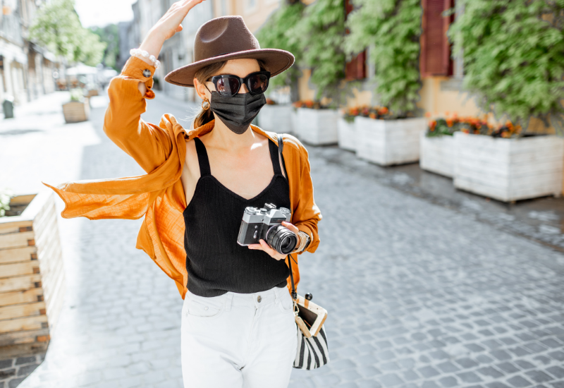 Traveler with COVID mask in an old city