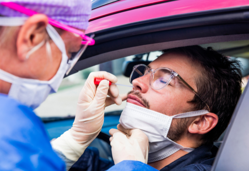 Traveler receiving a nasal swab for covid test